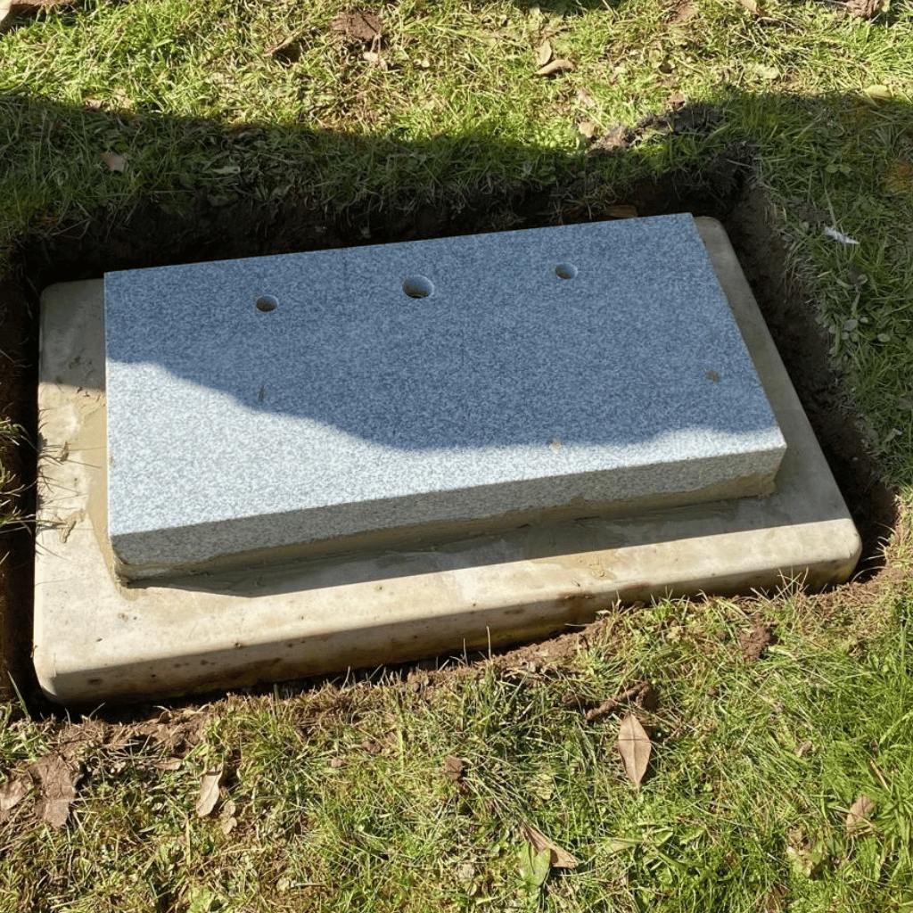 Memorial base positioned over a prepared foundation