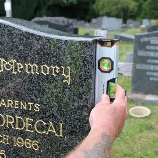 A level being held against a memorial
